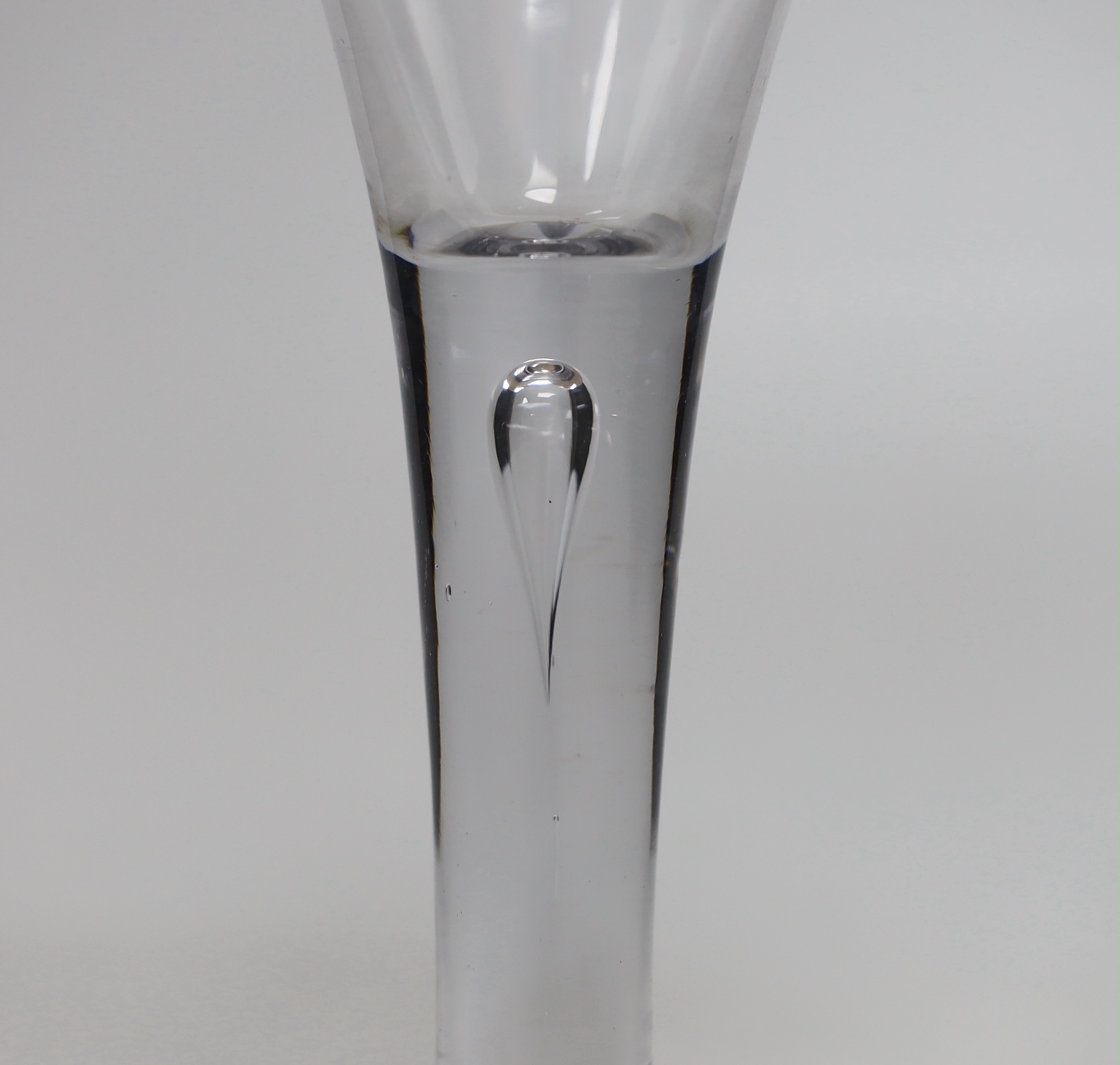 An English Georgian lead crystal mammoth drawn trumpet goblet, with good tear in the stem, folded foot and rough pontil, 21.6cm high